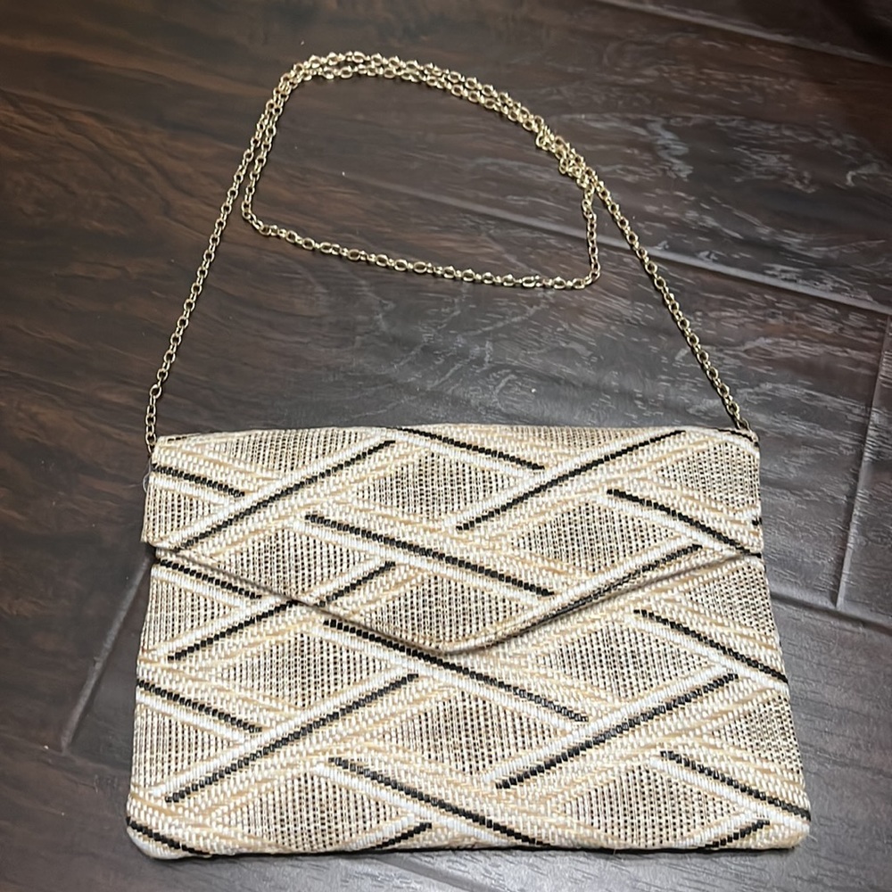 Black, white, and tan clutch with option gold chain strap